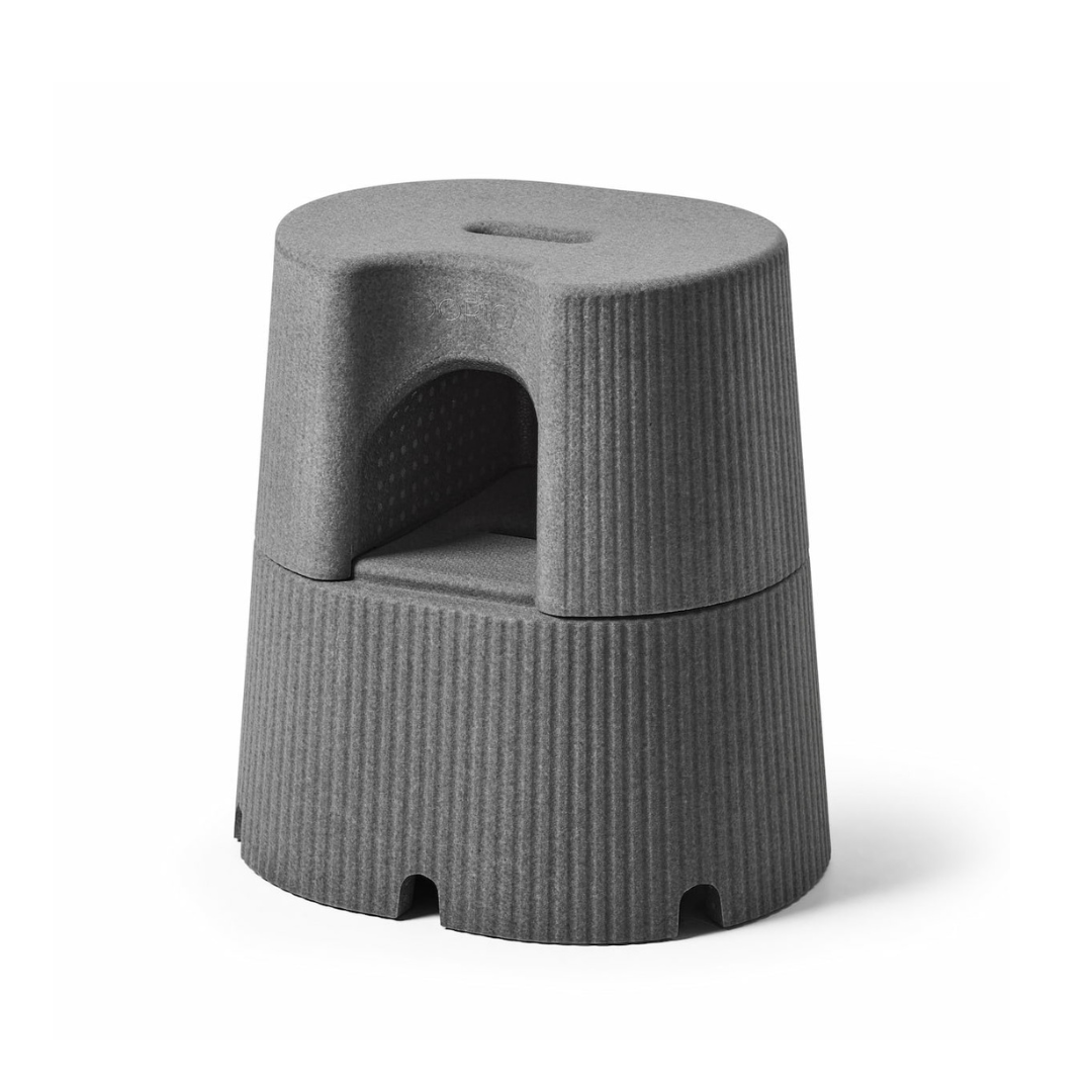 The byACRE DORICA Versatile Step Stool & Seat features a modern gray design, textured anti-slip surface, built-in handle, central cutout, and is water-resistant—ideal as both a step stool and an extra seat.